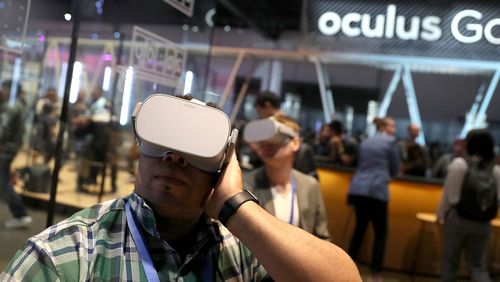 Attendees use the Oculus Go VR headset during the 2018 F8 Facebook Developers conference in San Jose, California.