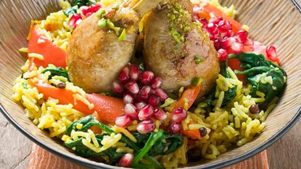 Chicken drumsticks with saffron rice and pomegranate seeds