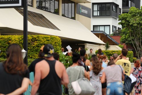 People queue outside Centrelink in Pam Beach on March 23, 2020 in Various Cities, Australia.