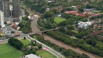 Aerial vision of Parramatta River which has seen flooding and debris congestion after heavy rainfall. 