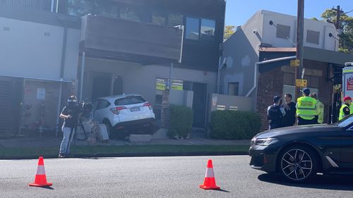 A car has smashed into a brick wall outside a house on Sydney's north shore.A woman in her 70s was trapped after the accident in Cammeray at 3.55pm.