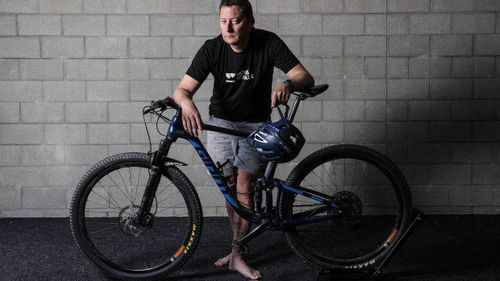 A security camera captured the moment a New Zealand mountainbiker, Mike Evans was deliberately knocked from his bike by the open door of a stolen car that police believe was driven by a child.