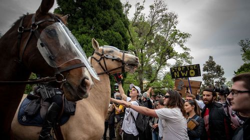 Protesters and members of Victoria Police clash on October 23, 2020 in Melbourne, Australia.