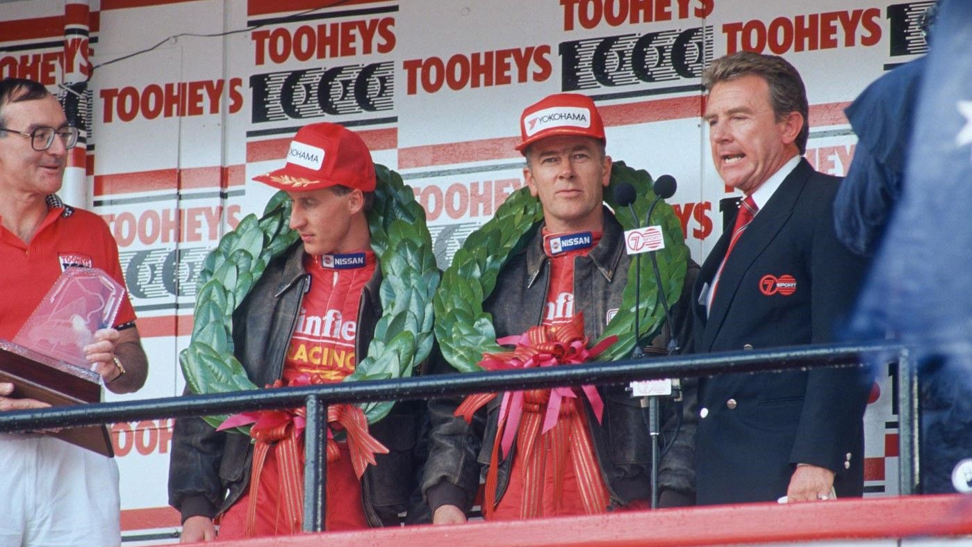 Mark Skaife (second left) and Jim Richards (second right) wear their winners&#x27; wreaths. 