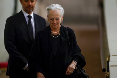 Denmark's Queen Margrethe pays her respect to the coffin of Queen Elizabeth II, following her death, during her lying-in-state at Westminster Hall.