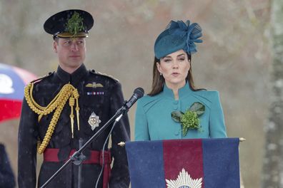 Prince William background listens as Kate, the Princess of Wales speaks on stage, at the St. Patrick's Day Parade at Mons Barracks, in Aldershot, England, Friday, March 17, 2023 