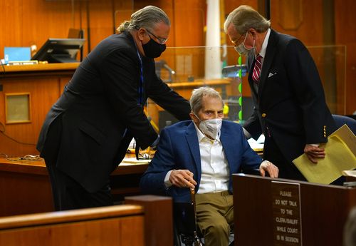 Defence attorneys Dick DeGuerin (R) and David Z. Chesnoff (L) adjust Robert Durst's wheelchair as he faces jurors. (Photo by Al Seib-Pool/Getty Images)