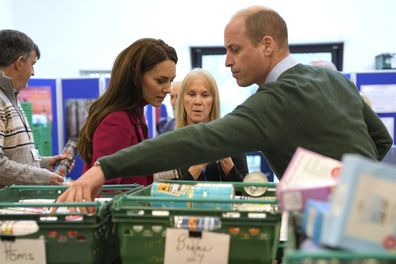 Kate, Princess of Wales, and Prince William check food baskets during a visit to Windsor Foodshare in Windsor, Thursday, Jan. 26, 2023 