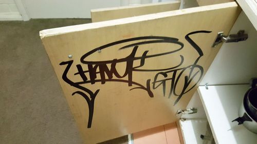 Graffiti shown on the cupboard door of a Redan apartment.