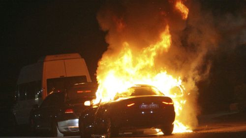 A car burns during firefight between Turkish army and Turkish police, in Istanbul's Taksim square. (AAP)