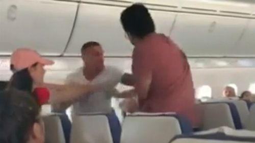 Footage of the incident shows some passengers struggling to restrain a man acting aggressively on Scoot flight TR7.