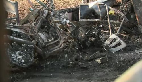 The 54-year-old's blackened motorcycle remains at the scene. Picture: 9NEWS