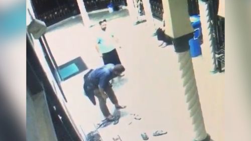 The man is seen keeled over after being punched. (Islamic Society of South Australia / Facebook)