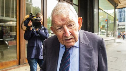 Sir Ron Brierley leaves the  Downing Centre Local Court after his appearance on possession of child abuse material charges.
