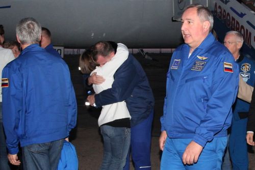 Hague is hugged by his wife on the tarmac after his return.