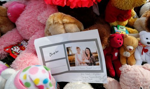 Tributes grow outside the home of the Watts family near Denver. 