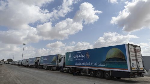 Aid convoy trucks wait at the Rafah border crossing for clearance to enter Gaza on October 19, 2023 in North Sinai, Egypt. 