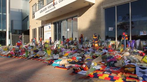 Hundreds of guernseys, jackets, beanies and scarves left as tributes for Phil Walsh donated to Adelaide’s homeless