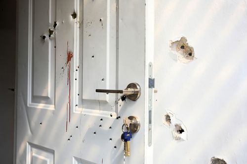 Gunshots and blood stains on a door and walls of a house in a kibbutz where civilians were killed days earlier in an attack by Hamas militants.