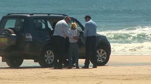 A woman is comforted at the scene of a fatal shark attack at Byron Bay. (9NEWS)