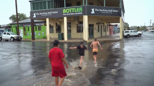 Children celebrate the first downpour in months in Coonamble, NSW.