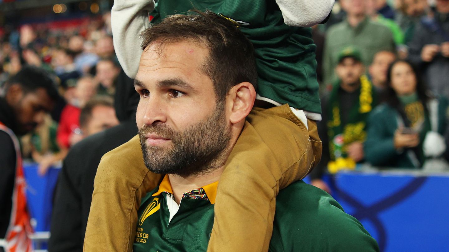 Cobus Reinach of South Africa celebrates victory with a child.