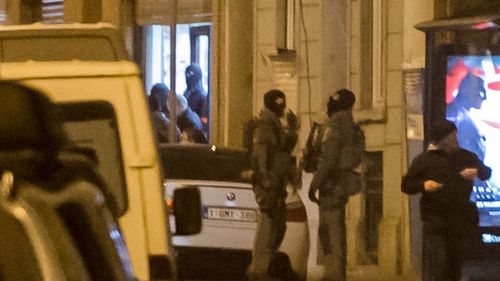 Belgian special intervention forces leave a house after a raid in the Molenbeek neighborhood. (AAP)