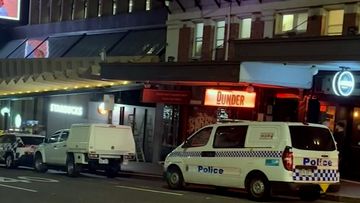 Police cars outside a Brisbane hostel