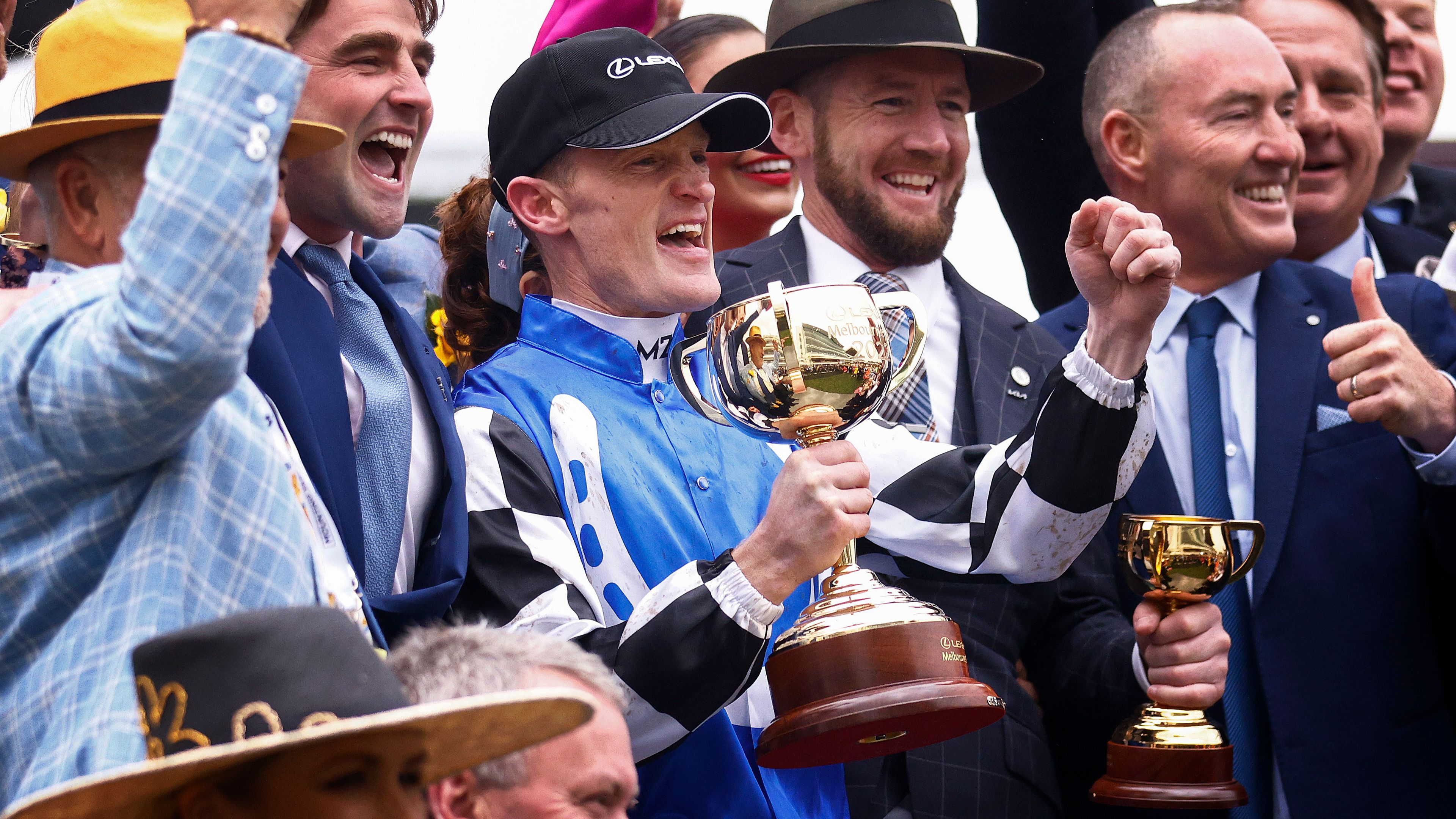 Mark Zahra who rode Gold Trip (C) celebrates with the trophy after winning race seven, the Lexus Melbourne Cup during 2022 Lexus Melbourne Cup Day at Flemington Racecourse on November 01, 2022 in Melbourne, Australia. 