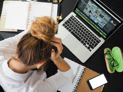 Stock photo of a woman stressed on her laptop.