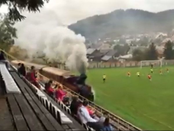Steam train chugs through football ground