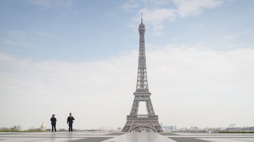 Police patrol an isolated Eiffel Tower