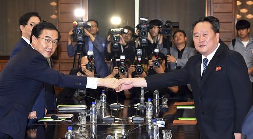 South Korean Unification Minister Cho Myoung-gyon, left, shakes hands with his North Korean counterpart Ri Son Gwon during their meeting at the northern side of Panmunjom in the Demilitarized Zone, North Korea, Aug. 13, 2018