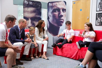 Prince William, Duke of Cambridge, Princess Charlotte of Cambridge and Catherine, Duchess of Cambridge speak with athletes during a visit to SportsAid House at the 2022 Commonwealth Games on August 02, 2022 in Birmingham, England.  