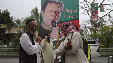 Supporters of former Prime Minister Imran Khan gather with sticks near the Khan&#x27;s residence, in Lahore, Pakistan, Friday March 17, 2023. 