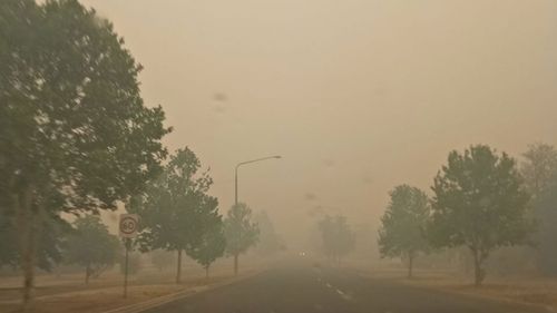 Smoke haze shrouds a road in Corowa, near the NSW and Victoria border, earlier today. Air quality in the town is at hazardous levels.