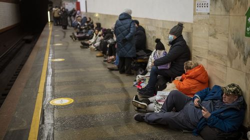 People lie in the Kyiv subway, using it as a bomb shelter in Kyiv, Ukraine, Thursday, Feb. 24, 2022. 