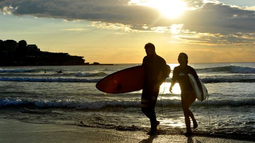 People enjoy the water at sunrise at Bondi Beach in summer. (AAP)