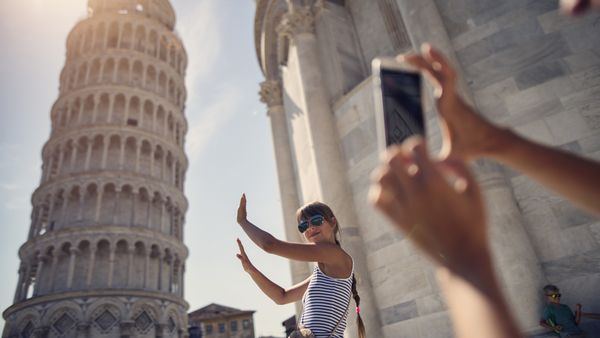 Woman taking photos at the Leaning Tower of Pisa