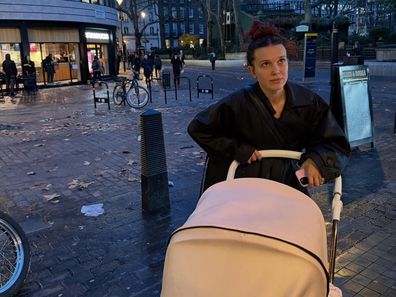 Millie Bobby Brown pushing her daughter in a pram