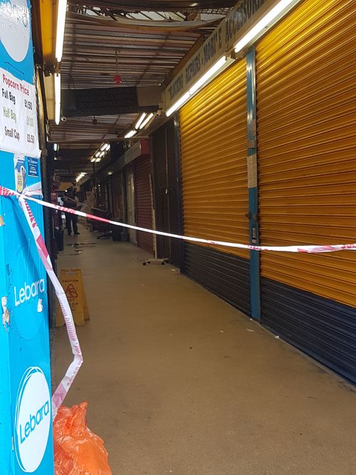 Police tape at the Reliance Arcade between Brixton Road and Electric Lane in south London, where a young woman who was was attacked with a noxious substance. (AAP)