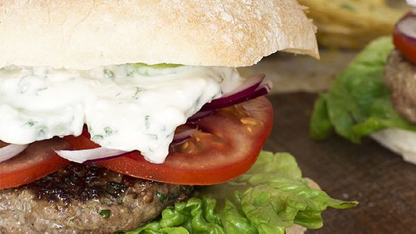Greek lamb burgers with creamy feta and cucumber sauce and lemony wedges