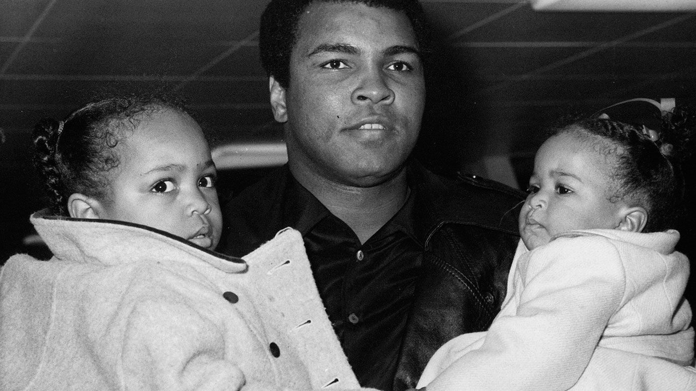  In this Dec. 20, 1978, file photo, World heavyweight champion Muhammad Ali carries his daughters, 2-year-old Hana, left, and nine-month-old Laila