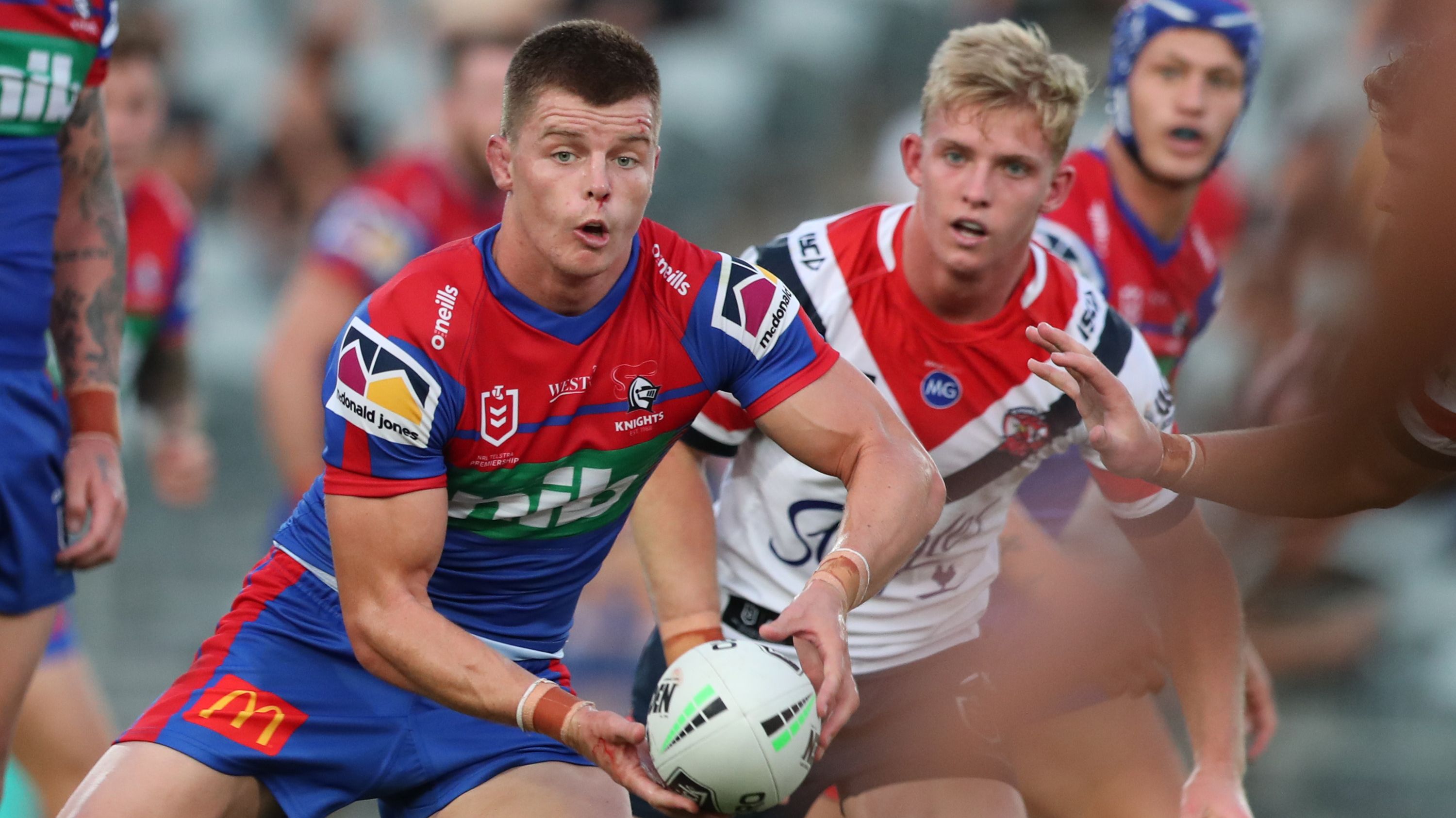 Jayden Brailey passes the ball during the NRL trial match between the Sydney Roosters and the Newcastle Knights.