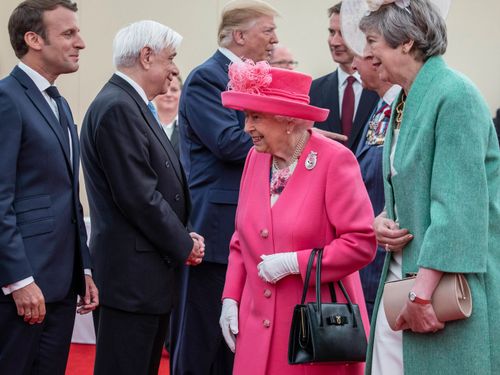 French Prime Minister Emmanuel Macron, Queen Elizabeth II and then-UK Prime Minister Theresa May meet at a D-Day event in 2019.