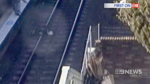 The pram lies on the tracks at Wentworthville station. (9NEWS)