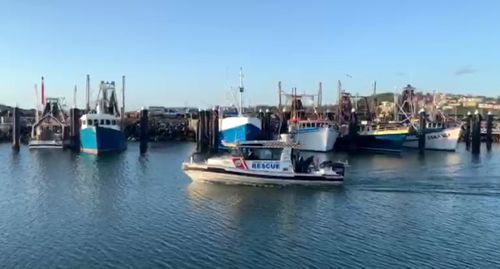 A police boat moves into Coffs Harbour after a so-far unsuccessful search for the two missing fishermen.