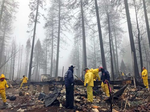 A deadly wildfire is nearly contained after several days of rain in Northern California, as volunteers continue to comb the rubble for signs of human remains.