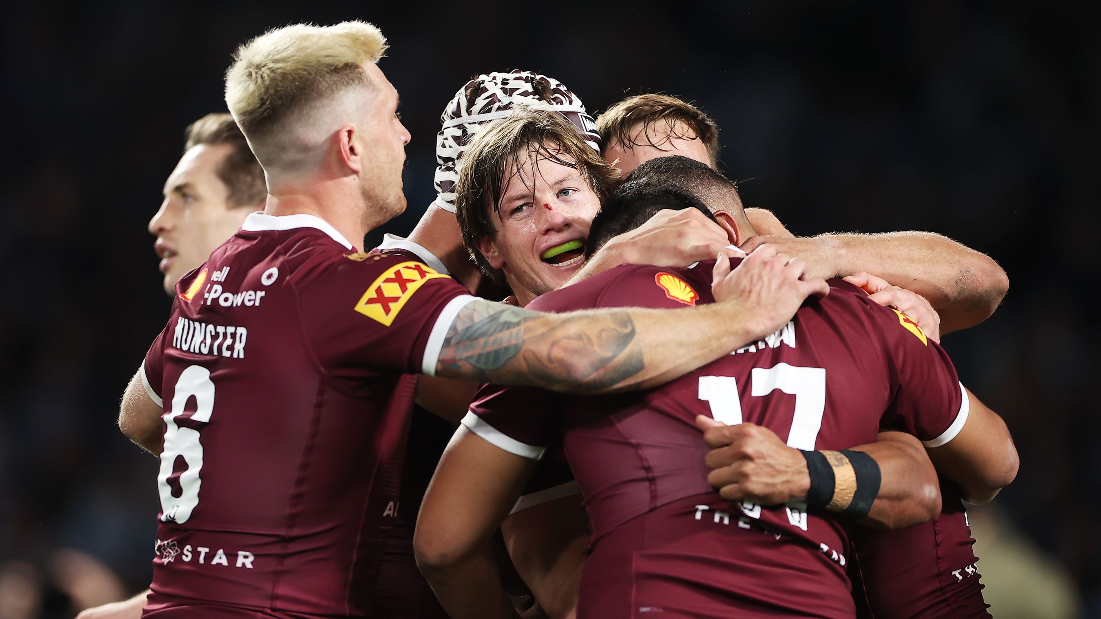 Dane Gagai of the Maroons celebrates with teammates after scoring a try.