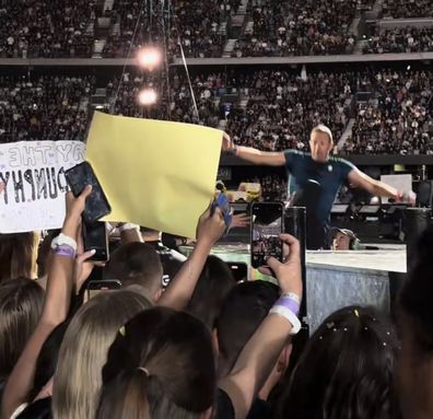 Chris Martin falls through a hole on the stage during Coldplay concert